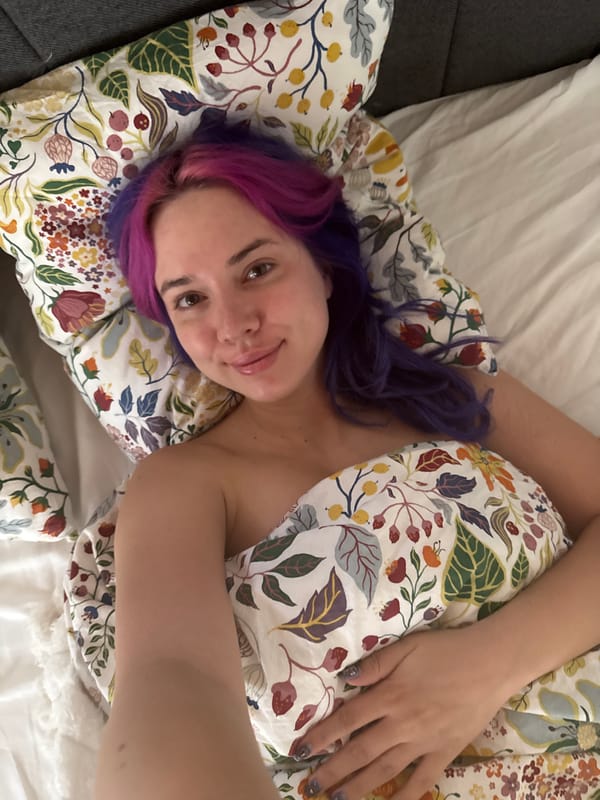 Purple-haired person photographed in bed in Zagreb morning