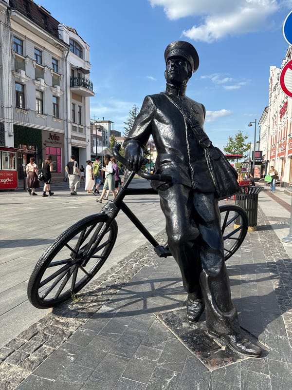 Bronze mail carrier sculpture on cobblestones in Nizhny Novgorod