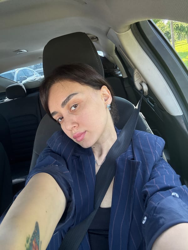 Woman takes morning selfies in car in Tbilisi