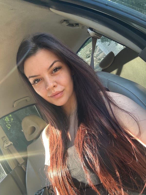 Woman takes early morning car selfies in Sliven, Bulgaria