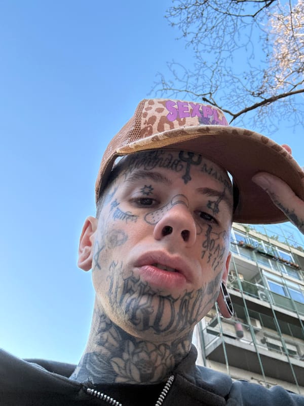 Tattooed individual spotted on Buenos Aires sidewalk wearing distinctive headwear