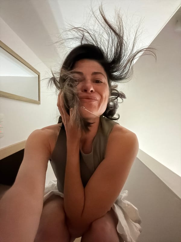 Woman photographs herself in bedroom in Budva, Montenegro