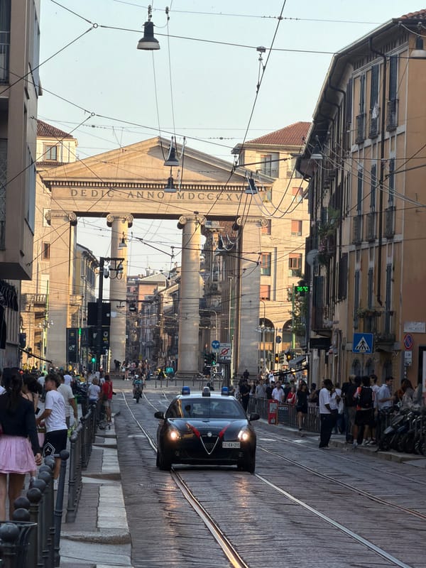 Milan street afternoon: shops, Vespas, and urban details