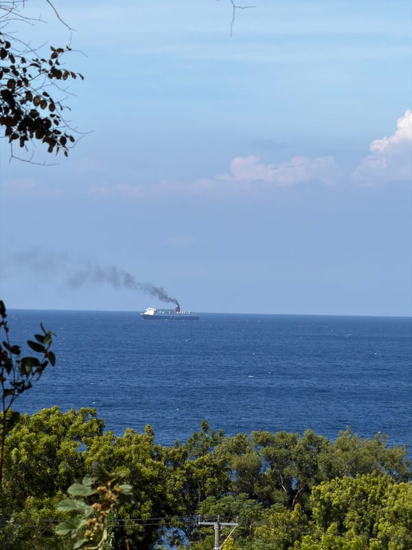 Morning scenes captured in Kubu: smoking ship, scooter rider, students