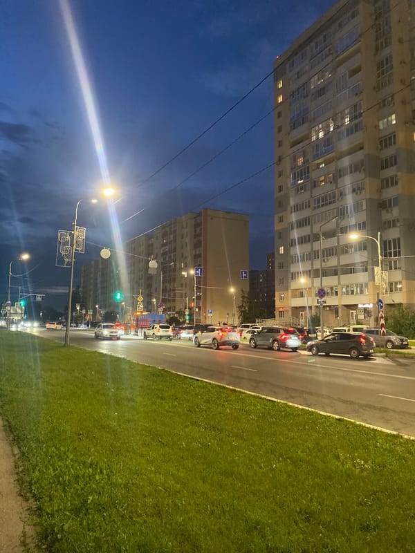 Dusk in Novokuybyshevsk: streets, river traffic, and a lit-up mall