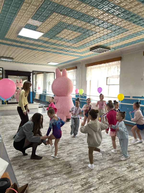 Children's medal ceremony and dance party with pink bunny mascot