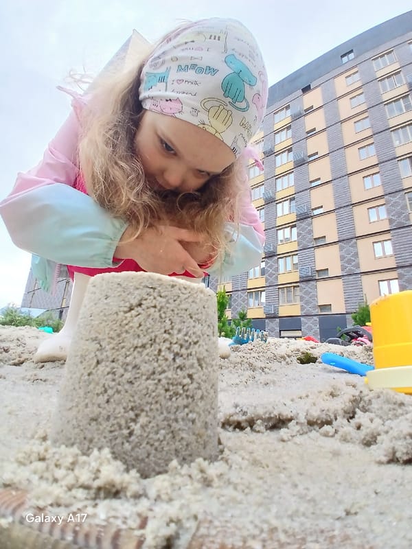 Child plays in sandbox and puddles in Yekaterinburg residential complex