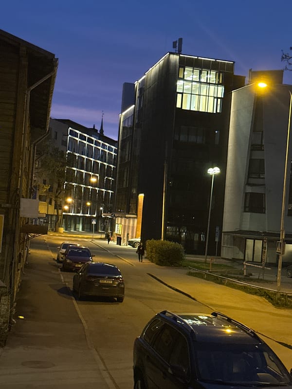 Illuminated modern building captured during Tallinn evening hours