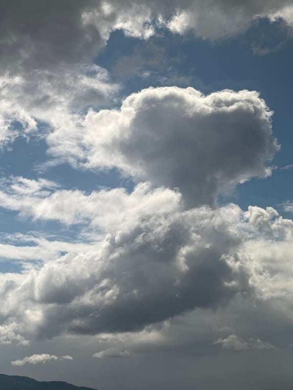 Witness Documents Dynamic Cloud Formations Against Blue Sky