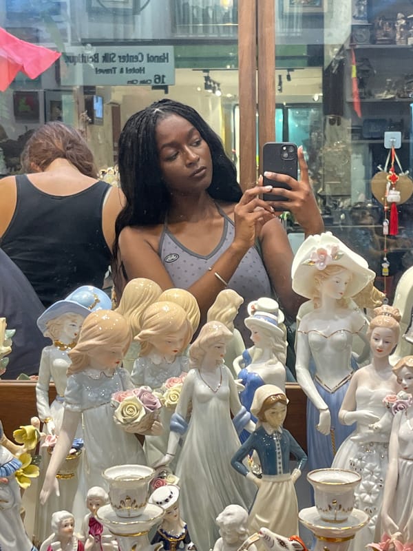 Woman takes selfie in Hanoi antique shop display
