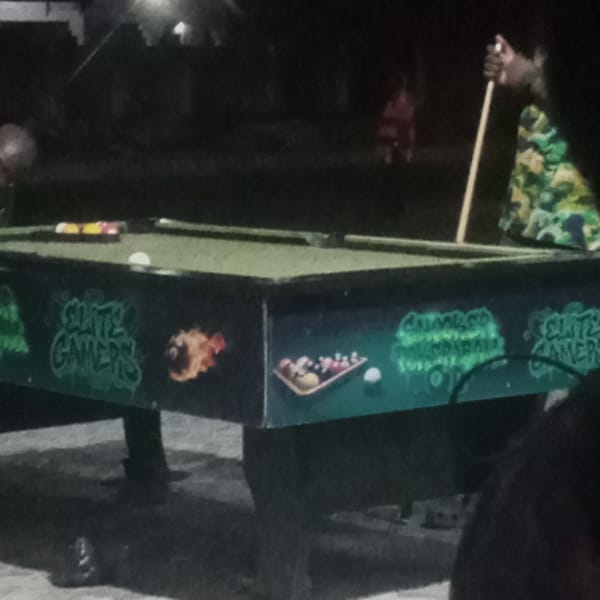 Outdoor gaming night: pool table, projected soccer, and PS5 controllers
