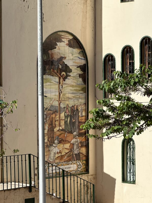 Religious crucifixion mural observed on Málaga building facade