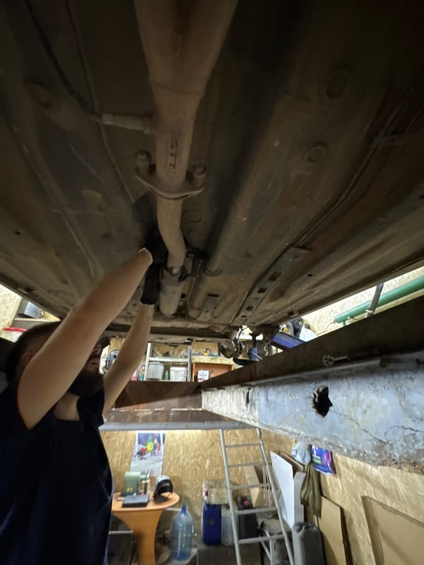 Mechanic performs routine car repair at Perm garage