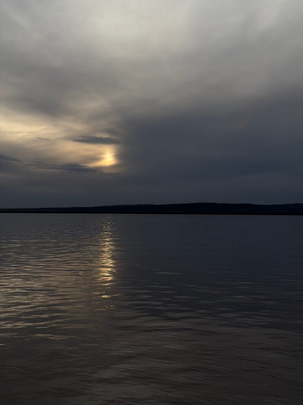 Sunlight breaks through clouds over Kama River near Chaikovsky