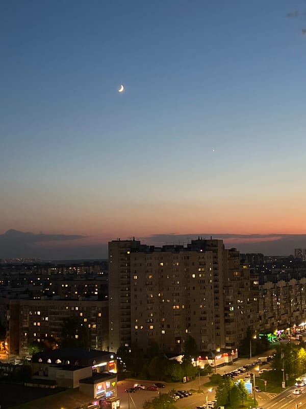 Dusk cityscape with crescent moon observed in Saint Petersburg