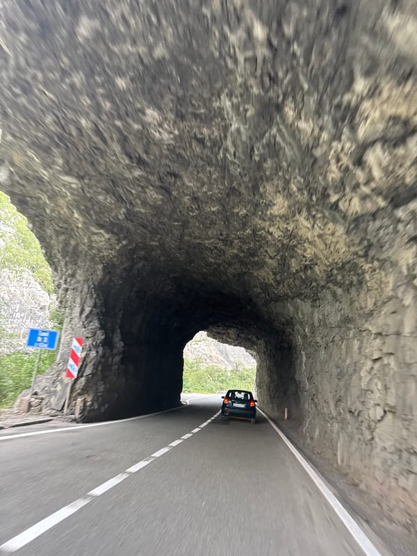 Driving through a rocky mountain tunnel in Montenegro