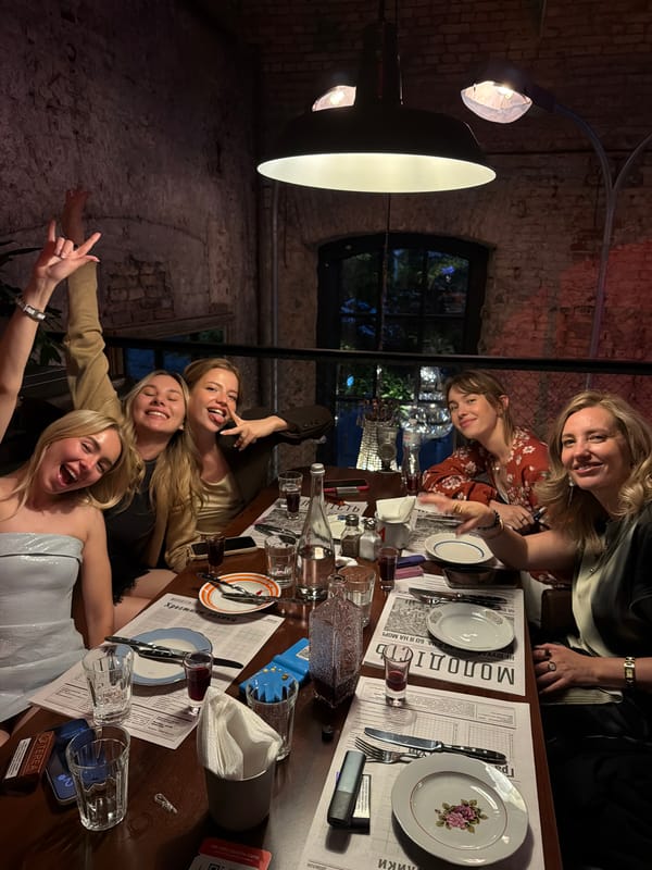 Evening dinner gathering at brick-walled restaurant in Kyiv