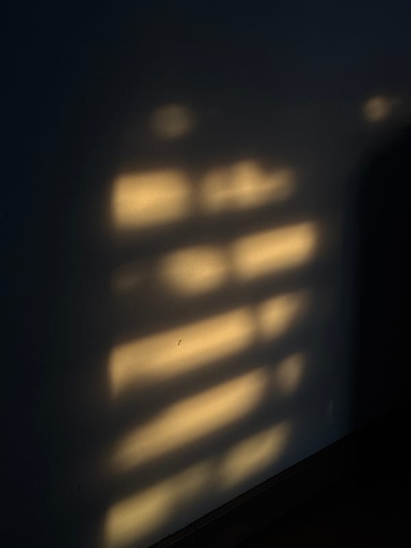 Golden sunlight creates striped shadows in Mexican home