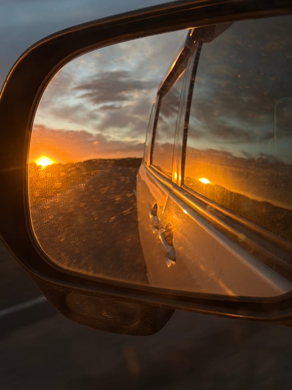 Vehicle mirror reflects sunset sky in Krasnaya, Russia