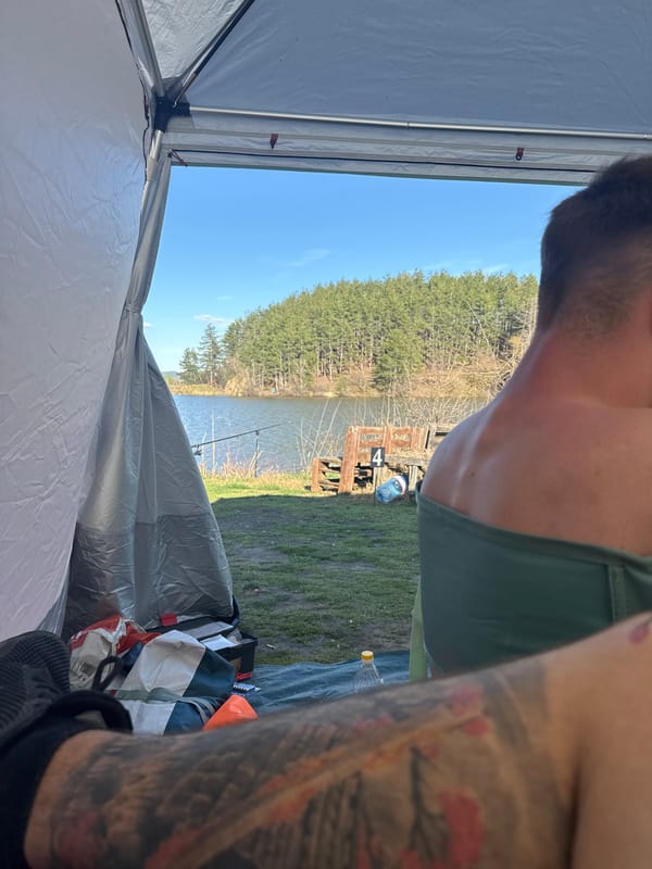 Person camping in tent by lake in Slavovitsa, Bulgaria