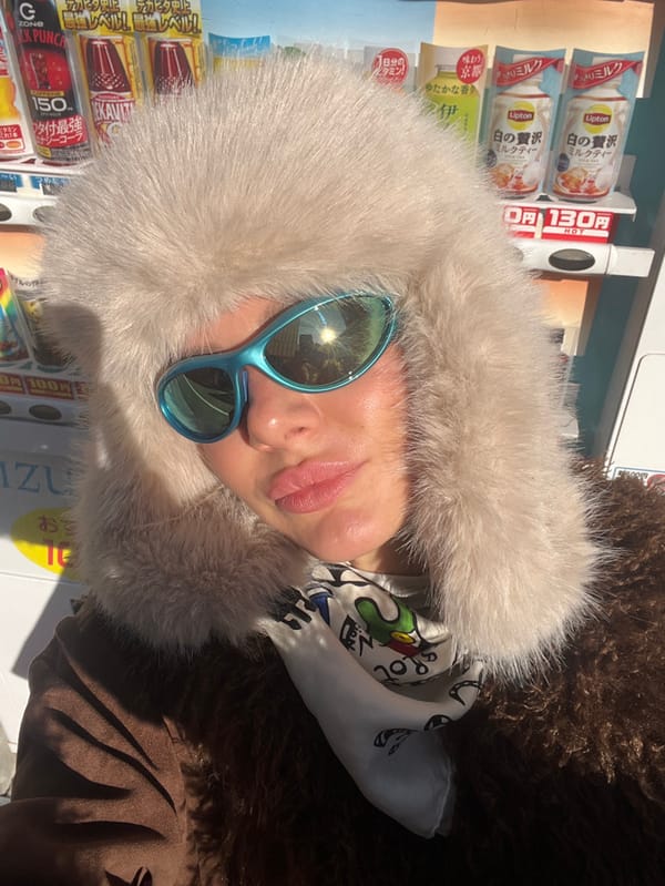 Person in blue sunglasses, fluffy hat spotted around Osaka