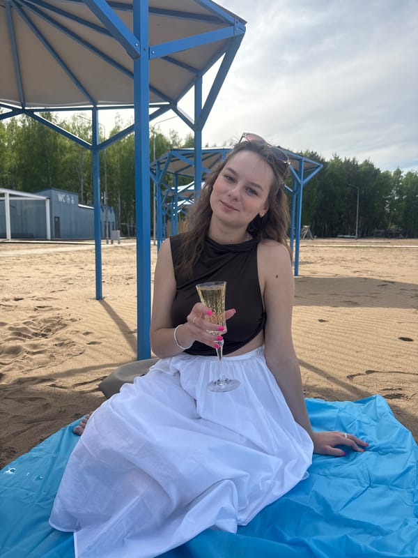 Woman enjoys beach day with drinks in Chaikovsky, Russia