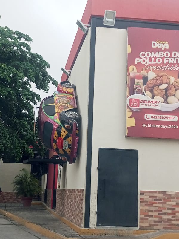 Fast-food restaurant displays decorated Volkswagen Beetle wall art in Venezuela