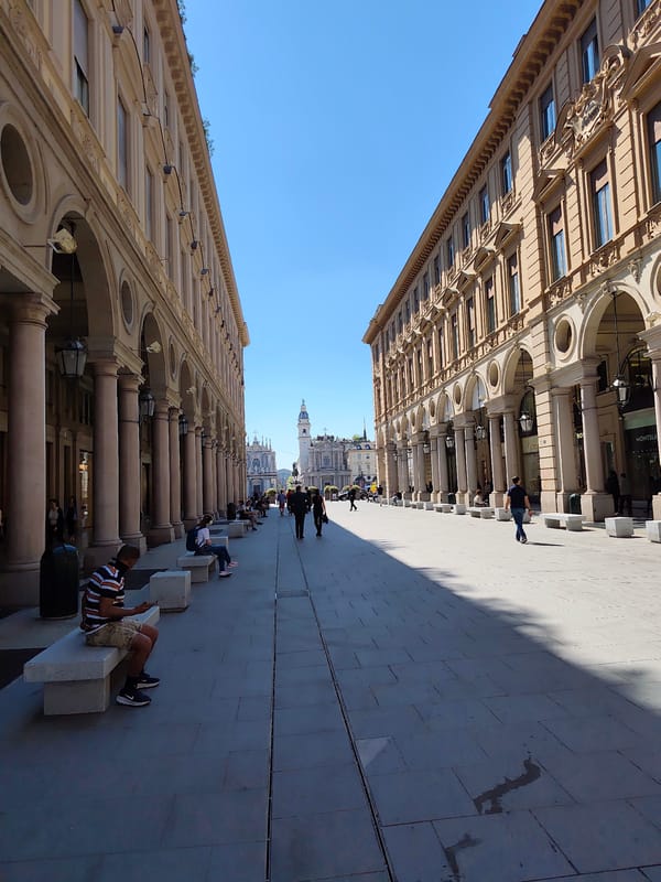 Turin shoppers encounter overturned head sculpture near Prada store