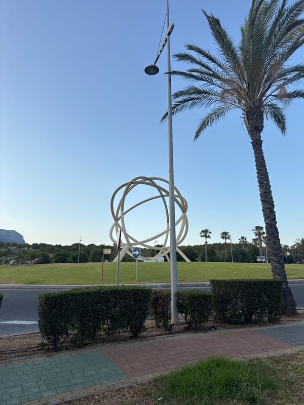 Benidorm roundabout sculpture and city skyline, June evening