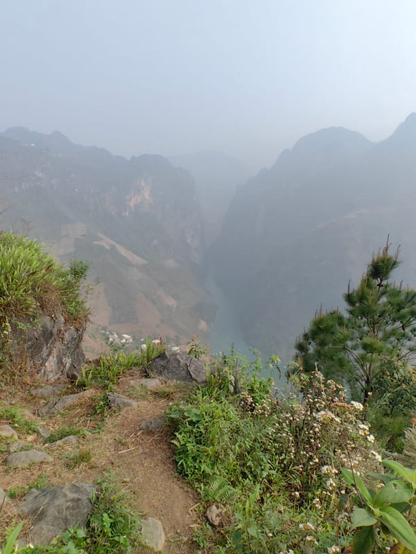 Tourists photograph mountain valley scenery in Vietnam