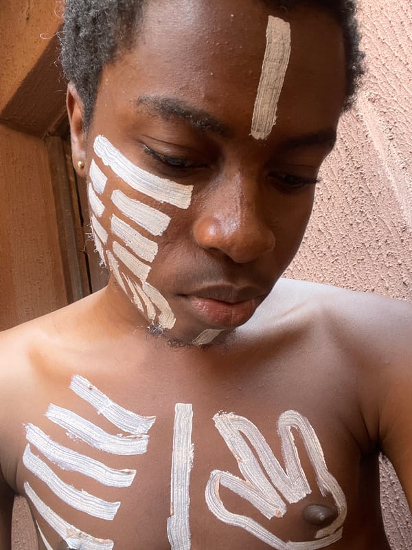 Young man photographed with traditional white body paint in Onitsha