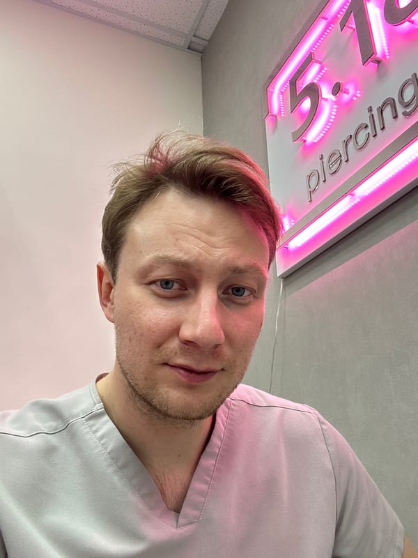 Medical worker takes selfie outside piercing shop in Sochi