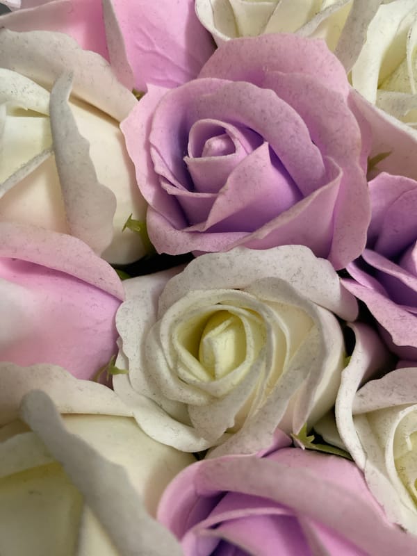 Close-up overhead look at artificial roses in soft pinks and lavender