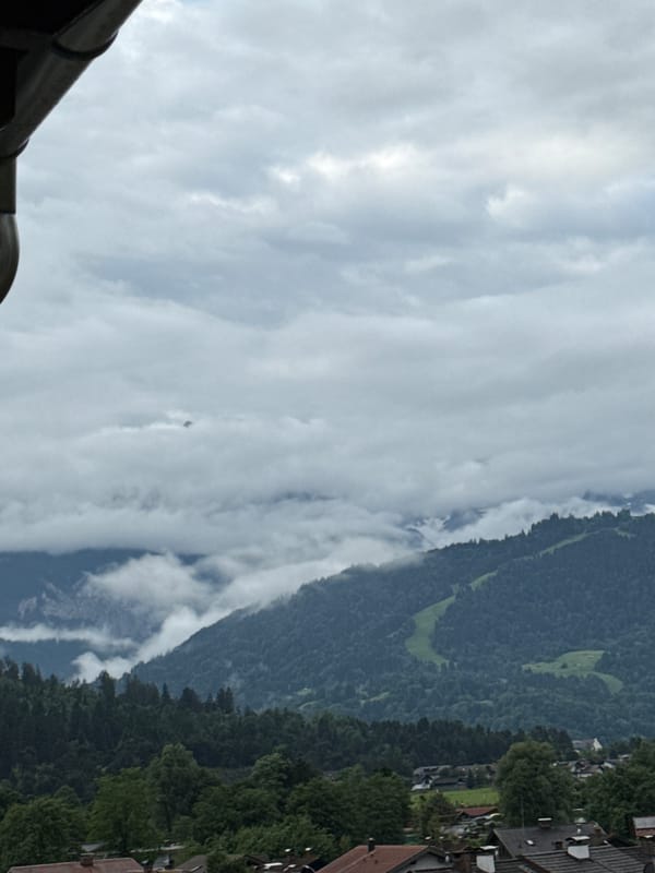 Morning balcony observations capture cloudy Garmisch-Partenkirchen residential mountain views