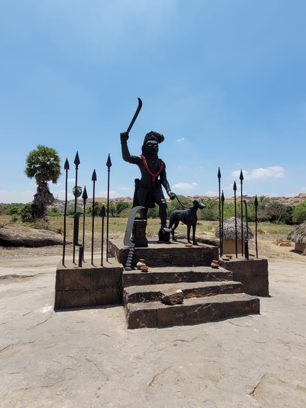 Historical settlement with dark statues photographed under blue skies