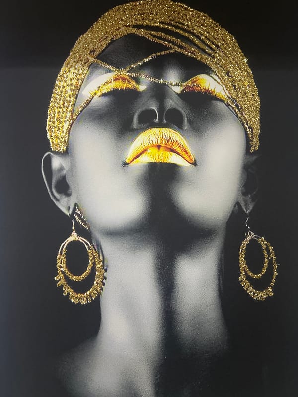 Portrait artwork with gold accents photographed on white wall