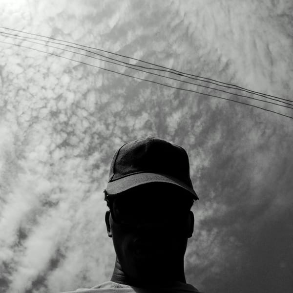 Person in baseball cap photographed under power lines