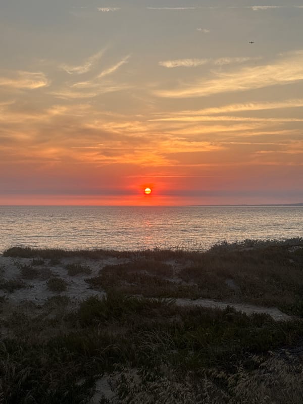 Atlantic sunset over Costa da Caparica's dunes, July evening