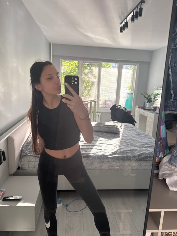 Woman takes early morning selfie in Sofia bedroom
