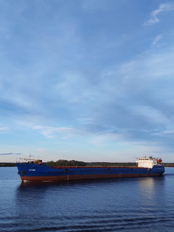 Cargo ships and tugboats transit Sheksna River in Russia