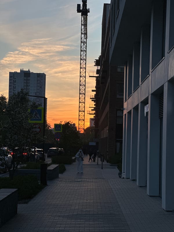 Sunset construction crane and modern buildings observed in Yekaterinburg