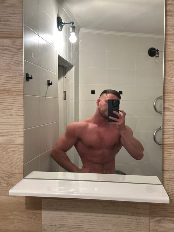 Person takes bathroom mirror selfie in Perm, Russia