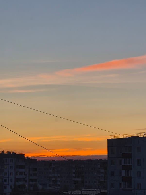 Child plays outdoors in Tobolsk during afternoon sunset