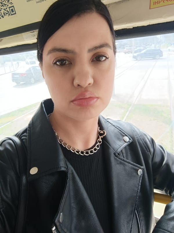 Woman in leather jacket observed in urban setting