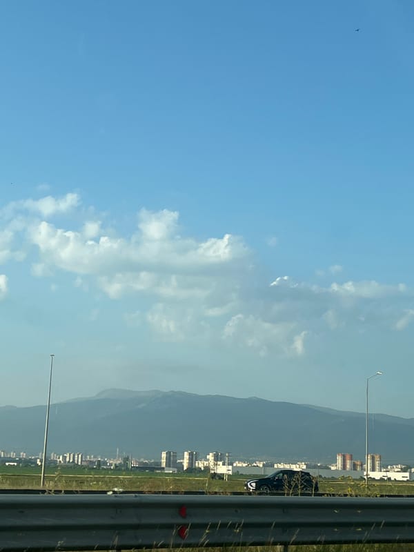 Open road, big skies, and distant mountains on a long drive