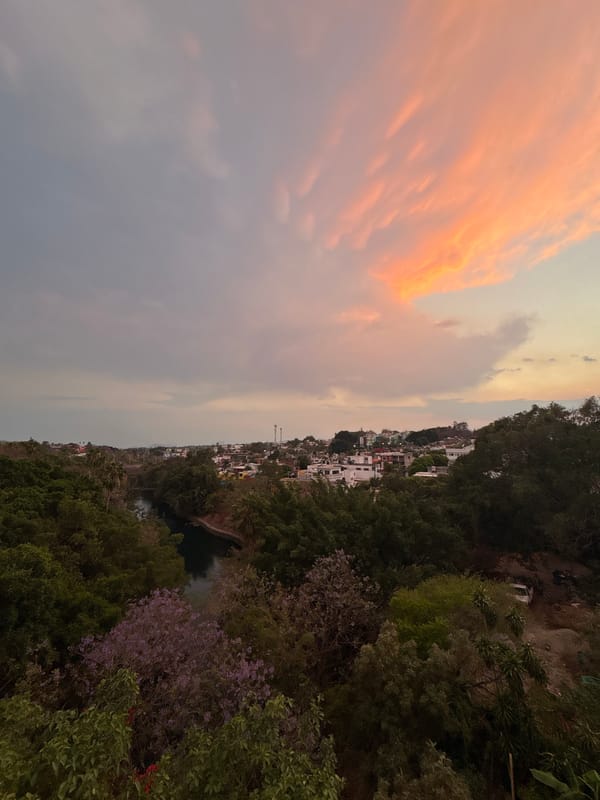 Dusk sky creates pink gradient over Cuernavaca cityscape