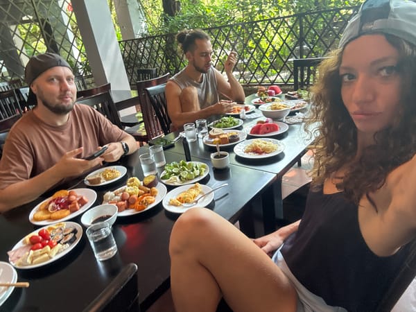 Three People Share Outdoor Meal in Đà Nẵng