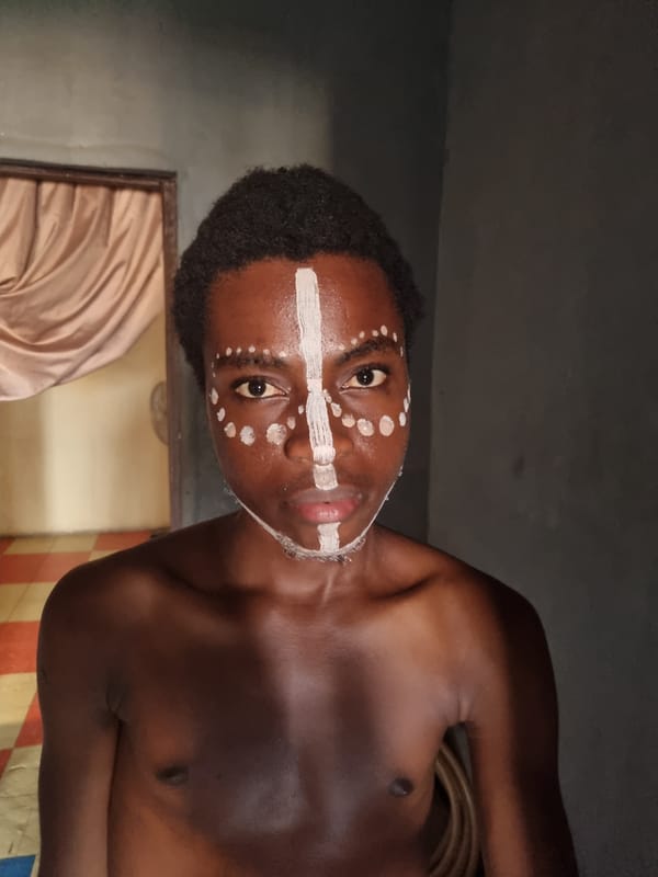 Traditional face paint application documented in Onitsha, Nigeria