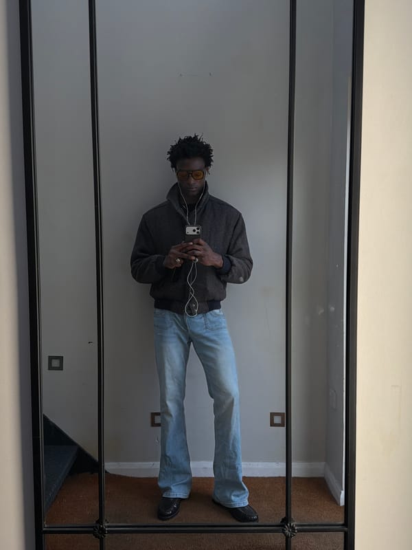 Person using phone with earbuds observed in London