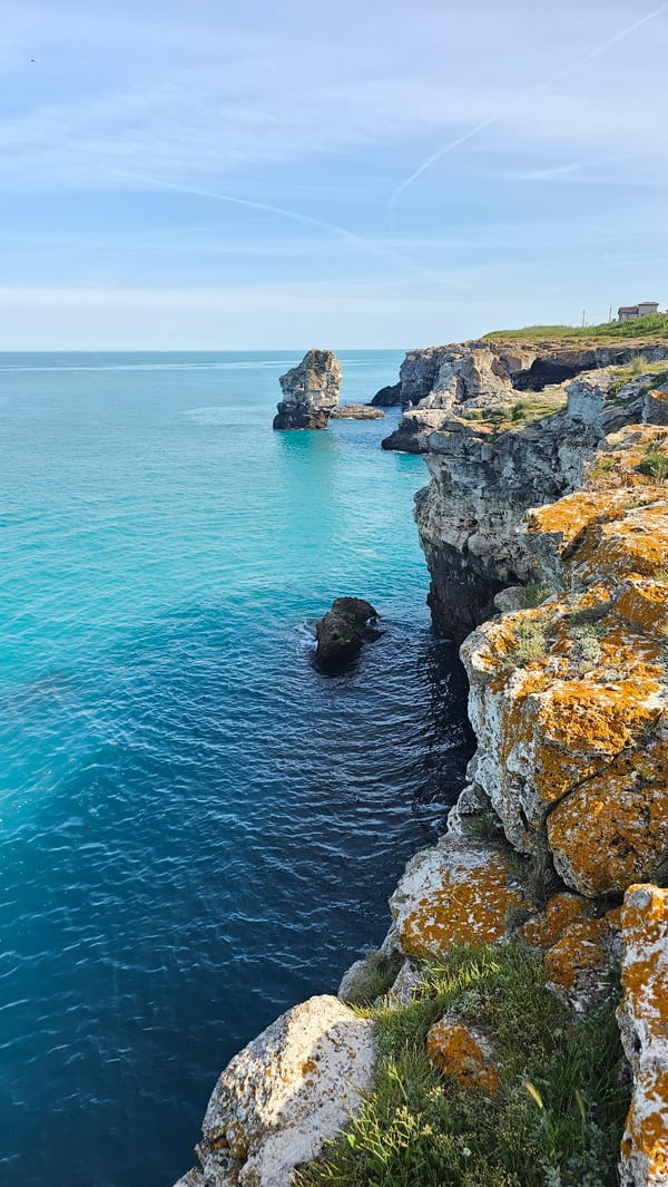 Visitor explores dramatic Tyulenovo coastline during afternoon Black Sea outing